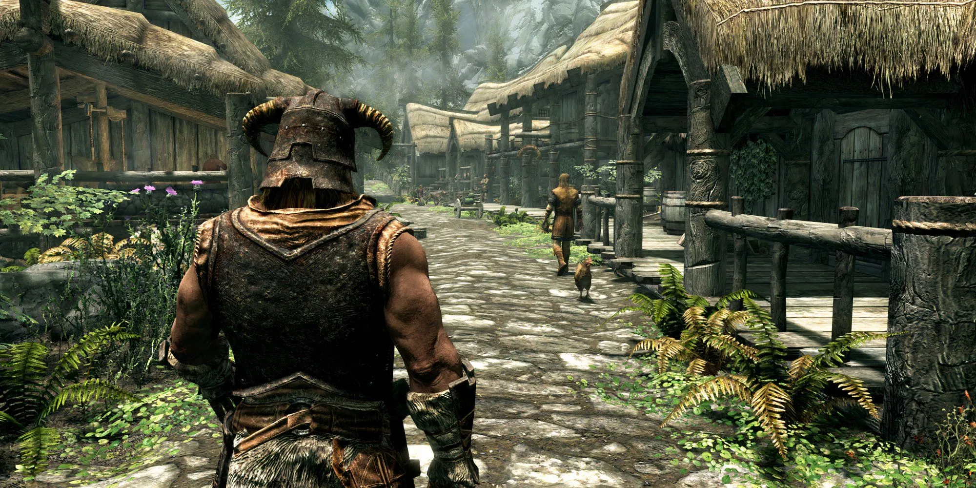 Nhân vật chính trong The Elder Scrolls V Skyrim nhìn từ phía sau, đứng giữa những ngôi nhà trong một khu định cư kiểu Bắc Âu