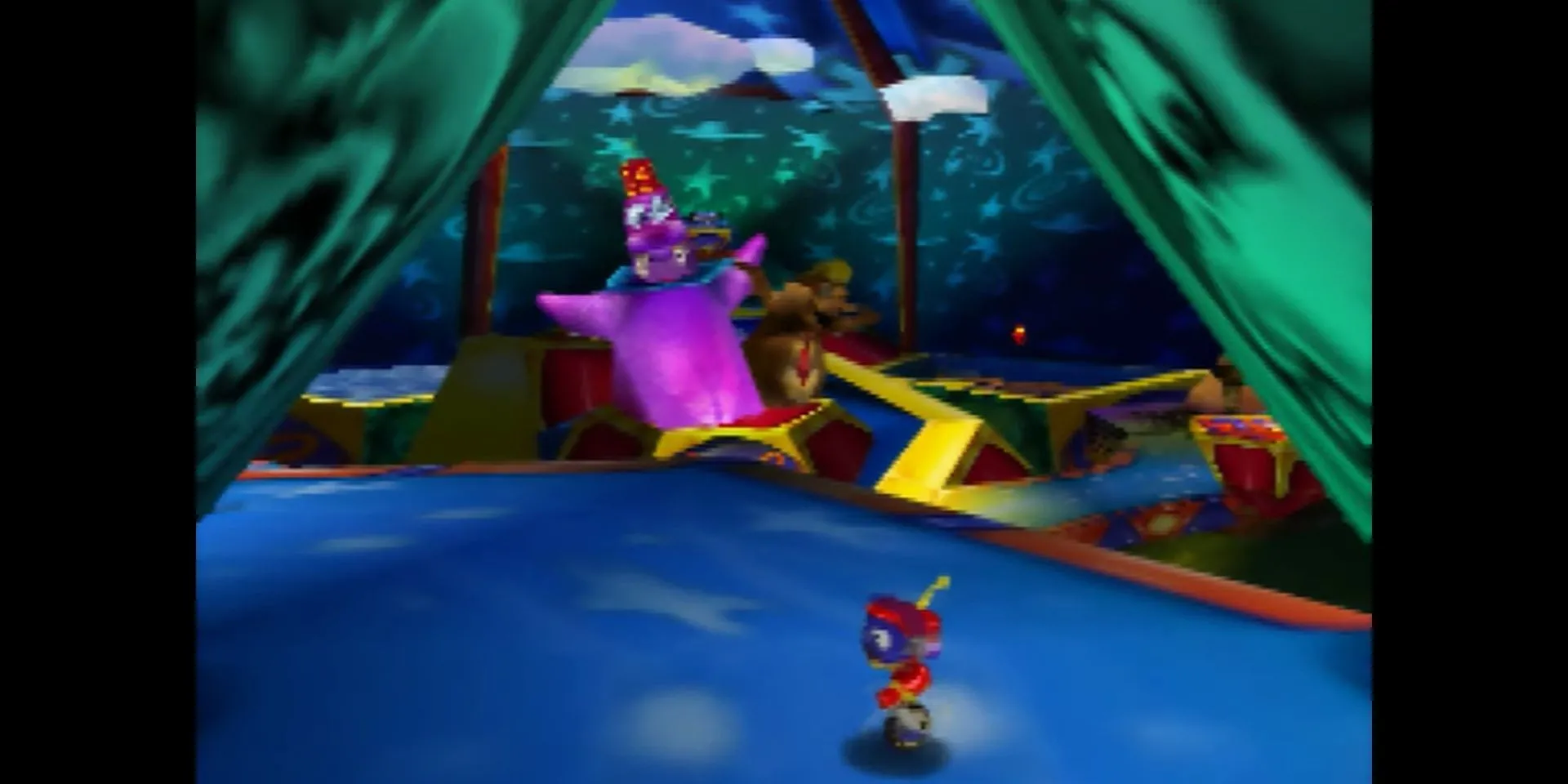 Robot Rocket đứng trước cổng công viên Whoopie World trong game platformer 3D Rocket: Robot on Wheels trên N64