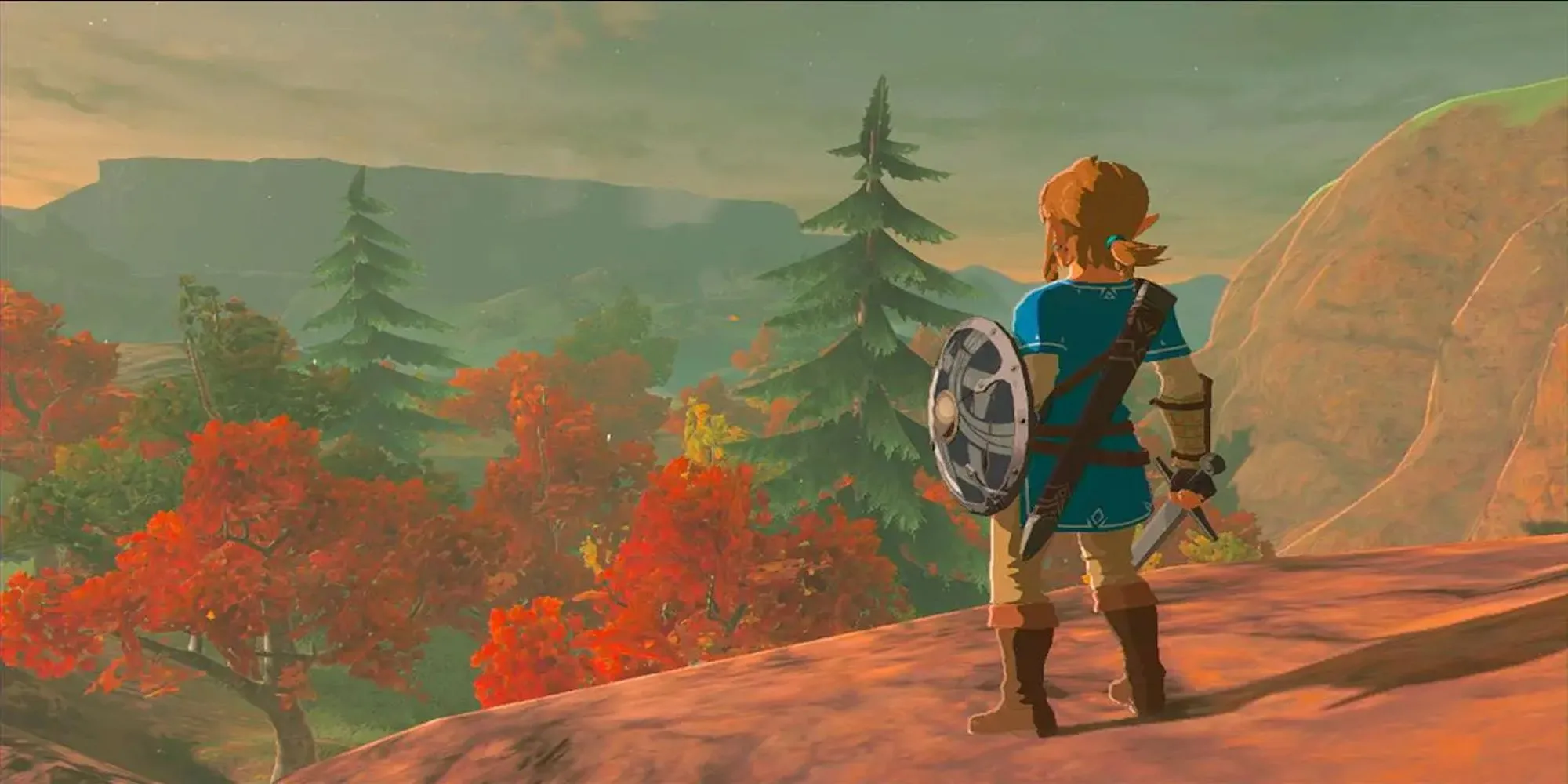 Link đứng trên vách đá nhìn xuống khung cảnh rộng lớn của Hyrule trong The Legend of Zelda: Breath of the Wild